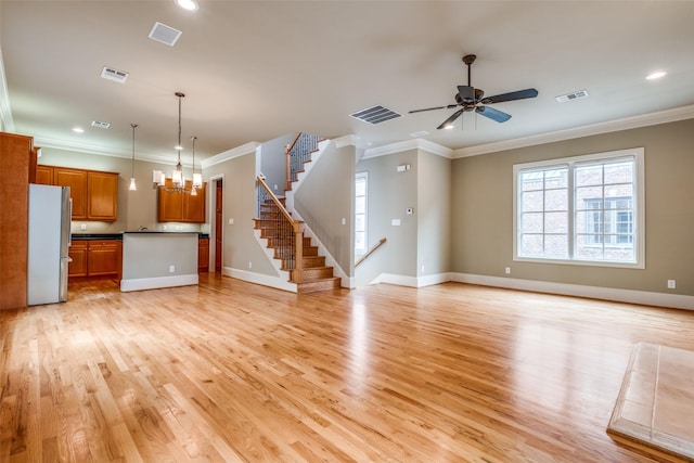 unfurnished living room featuring crown molding, visible vents, and light wood-style flooring