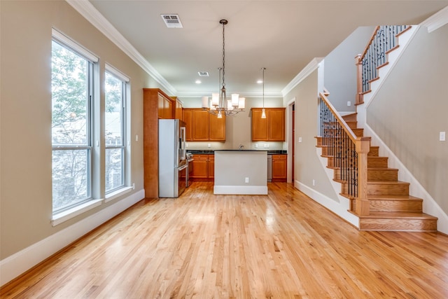 kitchen with brown cabinets, a notable chandelier, light wood-style floors, visible vents, and high quality fridge