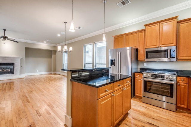 kitchen featuring visible vents, appliances with stainless steel finishes, ceiling fan with notable chandelier, ornamental molding, and light wood-style flooring