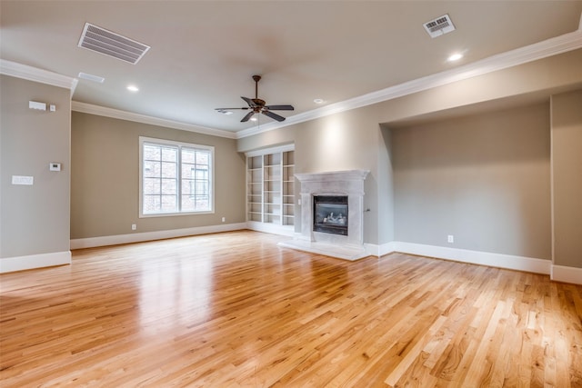 unfurnished living room with crown molding, baseboards, visible vents, and light wood-style flooring