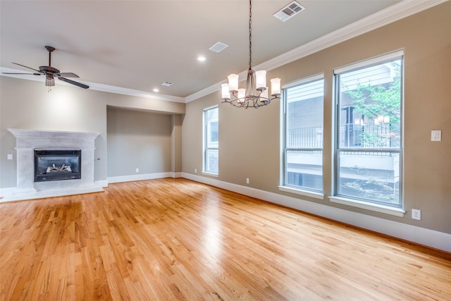 unfurnished living room with baseboards, ornamental molding, light wood-style flooring, and visible vents