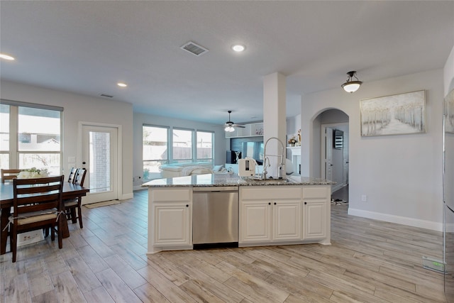 kitchen featuring a ceiling fan, visible vents, dishwasher, a sink, and baseboards