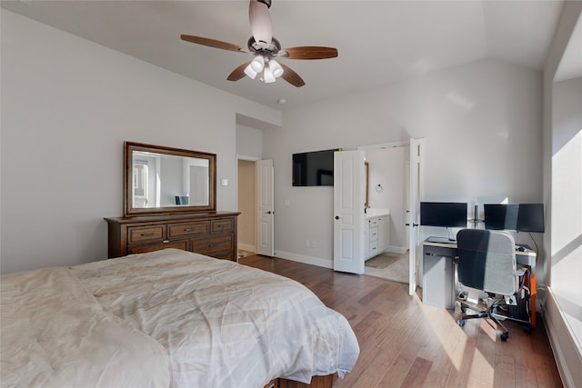bedroom featuring ensuite bathroom, lofted ceiling, wood finished floors, and ceiling fan