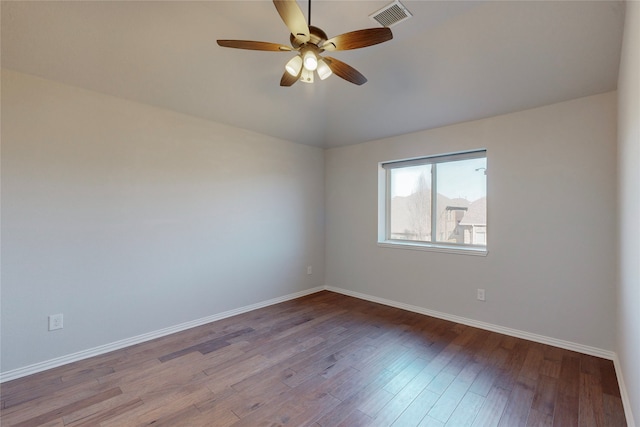 unfurnished room with visible vents, wood finished floors, baseboards, a ceiling fan, and vaulted ceiling