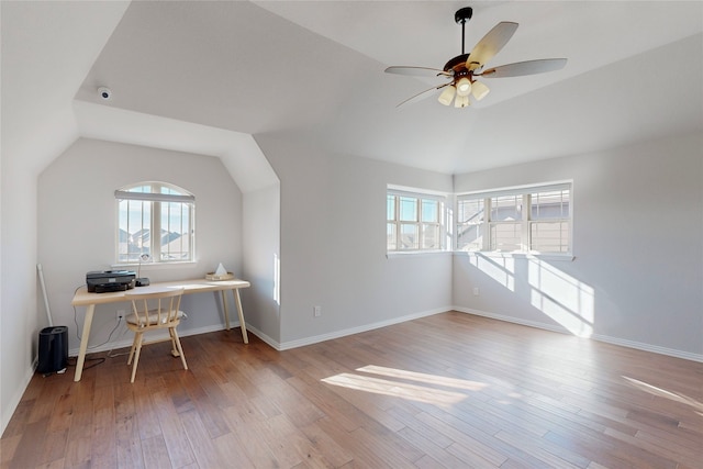 office with a healthy amount of sunlight, lofted ceiling, and wood finished floors