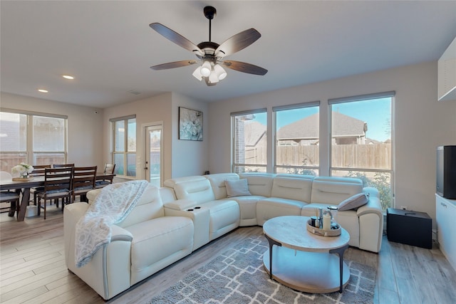 living area with a ceiling fan, recessed lighting, wood finished floors, and visible vents