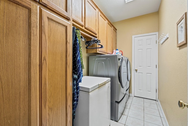 740 Bluebonnet Dr, Stephenville, TX 76401 - clothes washing area featuring baseboards, light tile patterned flooring, cabinet space, and washer and clothes dryer