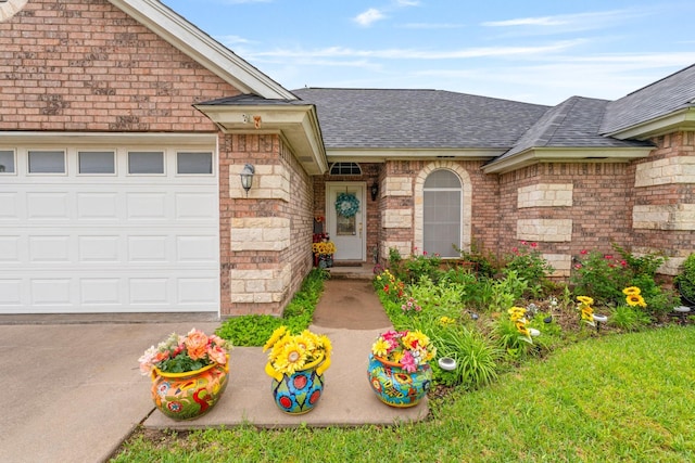 740 Bluebonnet Dr, Stephenville, TX 76401 - property entrance with an attached garage, driveway, and roof with shingles