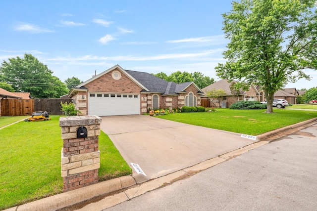 740 Bluebonnet Dr, Stephenville, TX 76401 - view of front facade with a front yard, a garage, brick siding, fence, and concrete driveway