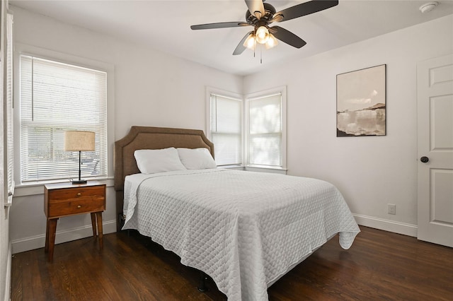 bedroom featuring baseboards, ceiling fan, and wood finished floors