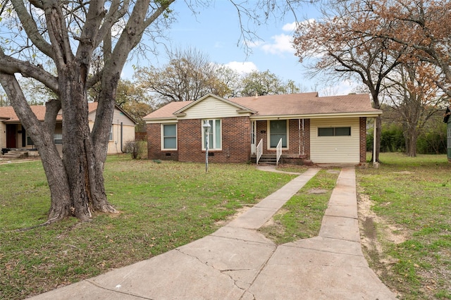 single story home featuring brick siding, entry steps, a front yard, and concrete driveway