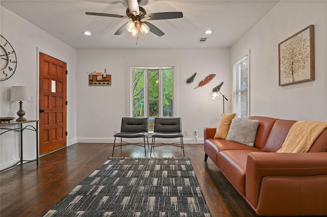 living area with ceiling fan, wood finished floors, and a wealth of natural light