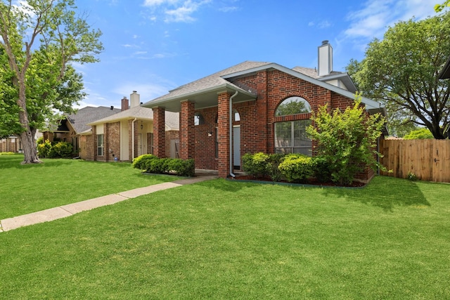 1308 Wheatfield Dr, Mesquite, TX 75149 - ranch-style house featuring brick siding, fence, a chimney, and a front lawn