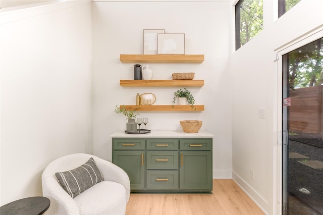 interior space featuring baseboards and light wood finished floors