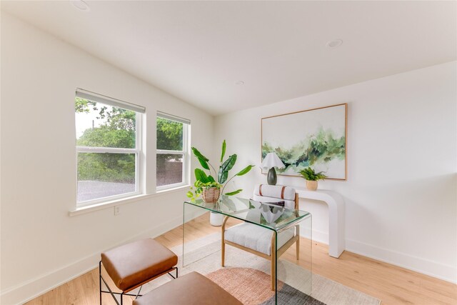 home office with baseboards and wood finished floors