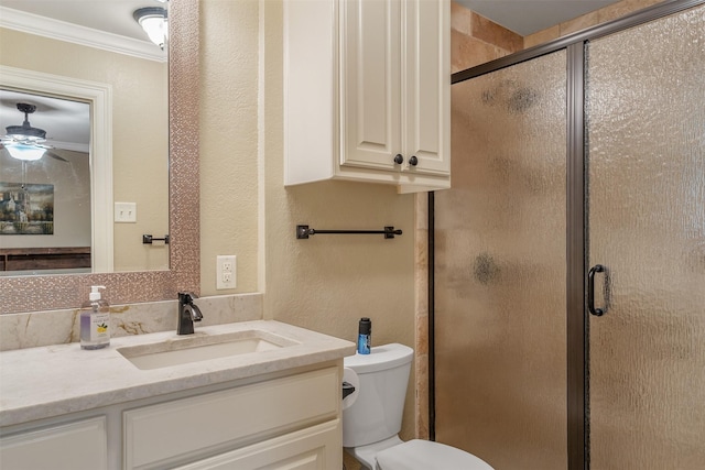 bathroom featuring vanity, ornamental molding, toilet, and a shower stall