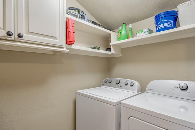 laundry room with cabinet space and washer and clothes dryer