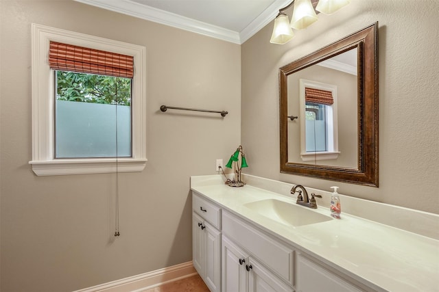 bathroom with vanity, ornamental molding, and baseboards