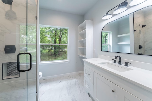 full bath featuring a stall shower, vanity, baseboards, toilet, and marble finish floor