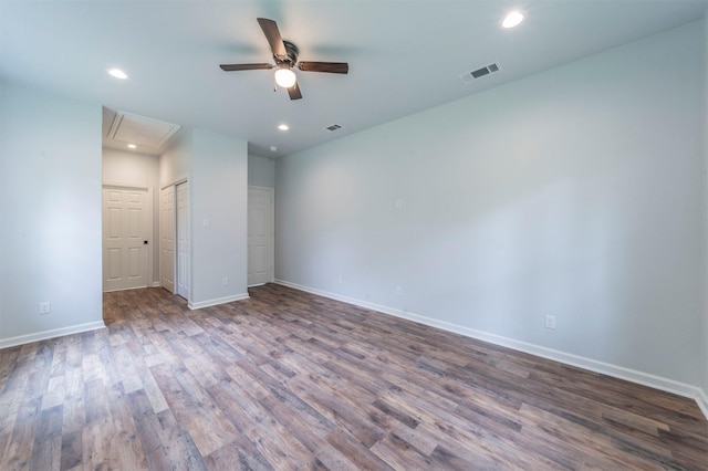 empty room featuring baseboards, a ceiling fan, attic access, and visible vents