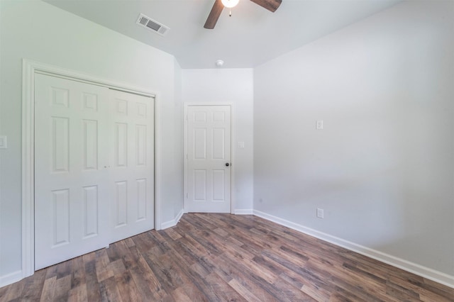 unfurnished bedroom with visible vents, a closet, wood finished floors, baseboards, and a ceiling fan