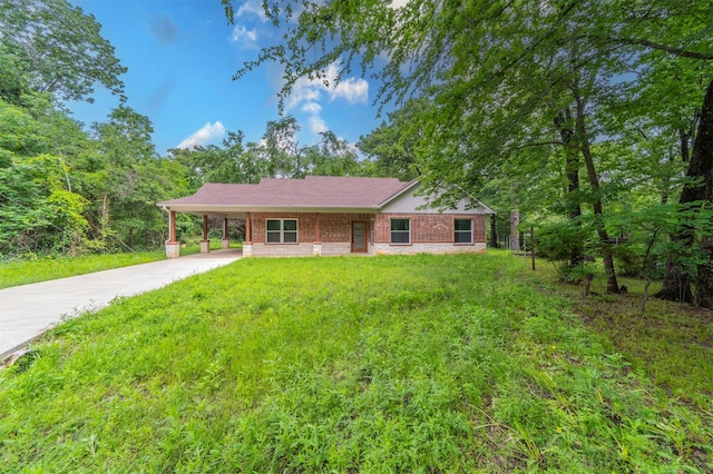single story home with concrete driveway, an attached carport, brick siding, and a front yard