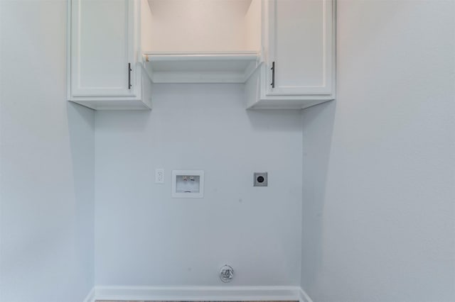 laundry area featuring baseboards, washer hookup, cabinet space, and hookup for an electric dryer