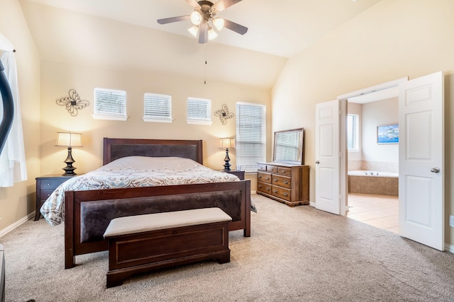 bedroom with carpet floors, baseboards, vaulted ceiling, and ensuite bath