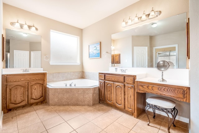 full bath with a bath, a sink, tile patterned floors, and two vanities