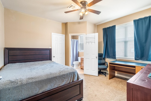 carpeted bedroom featuring connected bathroom, ceiling fan, and visible vents