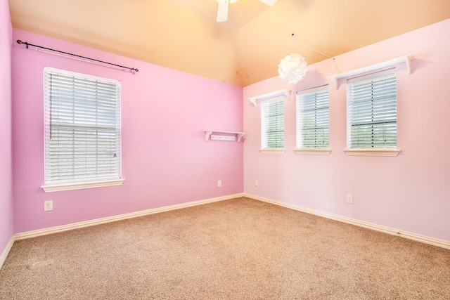 spare room featuring carpet floors, a ceiling fan, and baseboards