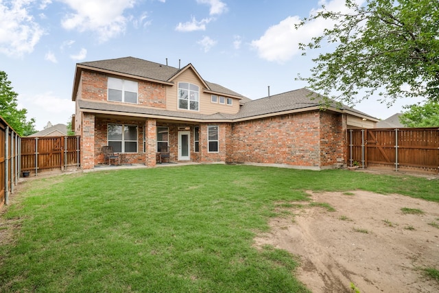 back of house with a fenced backyard, brick siding, a shingled roof, a patio area, and a yard