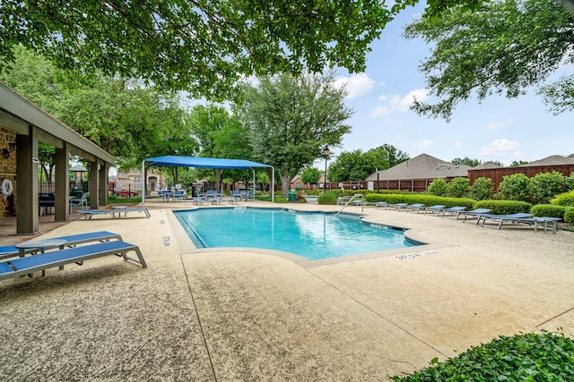 pool featuring a gazebo, a patio area, and fence