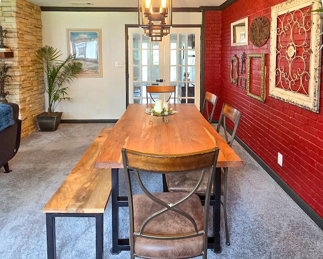 4512 Orchid St, Shreveport, LA 71105 - dining room featuring carpet, ornamental molding, baseboards, and a chandelier
