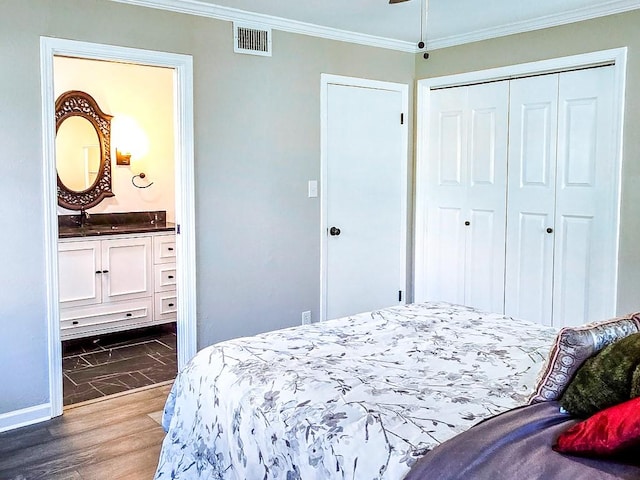 4512 Orchid St, Shreveport, LA 71105 - bedroom featuring ornamental molding, a closet, connected bathroom, wood finished floors, and baseboards