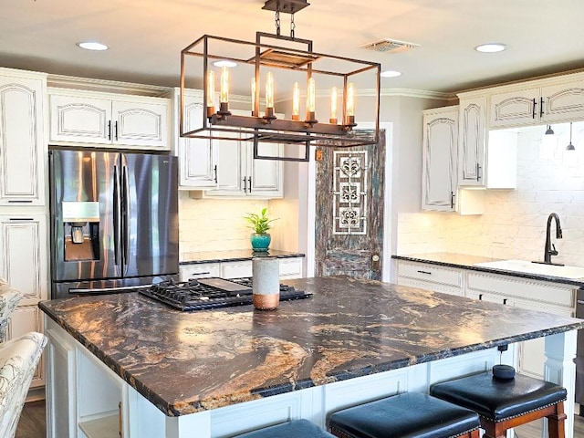 4512 Orchid St, Shreveport, LA 71105 - kitchen with stainless steel fridge with ice dispenser, a sink, tasteful backsplash, a chandelier, and crown molding