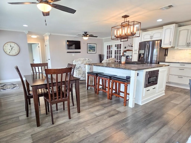 4512 Orchid St, Shreveport, LA 71105 - dining room with a ceiling fan, ornamental molding, wood finished floors, recessed lighting, and baseboards