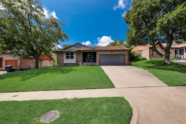 ranch-style house with fence, an attached garage, brick siding, a front yard, and concrete driveway