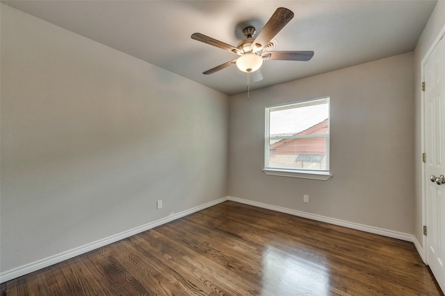empty room with dark wood-style flooring, baseboards, and ceiling fan