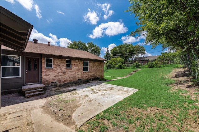view of yard featuring a patio and fence