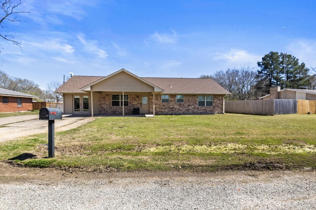 ranch-style house featuring a front lawn, fence, french doors, brick siding, and a shingled roof