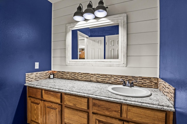 bathroom with vanity and decorative backsplash