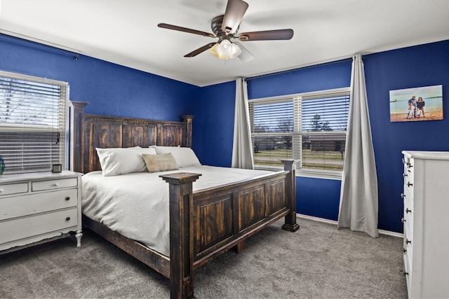 carpeted bedroom featuring baseboards, ceiling fan, and multiple windows