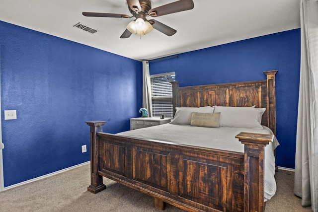 bedroom featuring baseboards, ceiling fan, carpet flooring, and visible vents