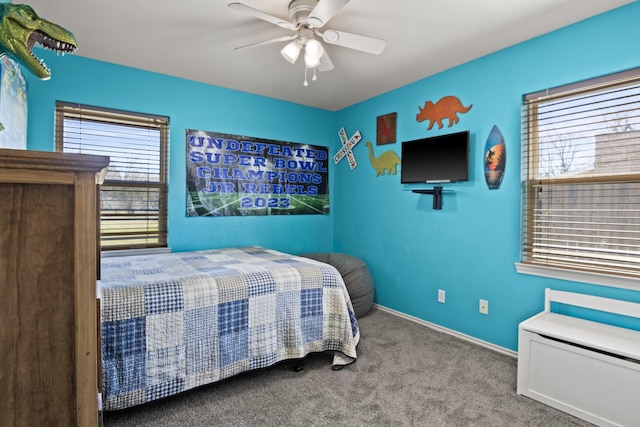carpeted bedroom with baseboards and a ceiling fan
