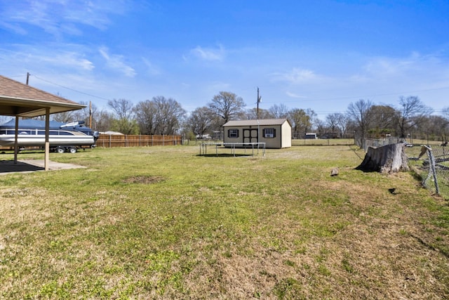 view of yard featuring fence and an outdoor structure