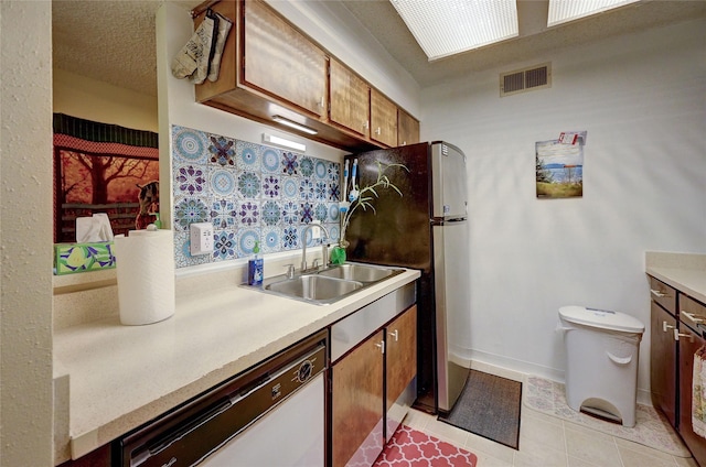 4405 Tophill Ln, Irving, TX 75038 - kitchen featuring visible vents, white dishwasher, a sink, light countertops, and freestanding refrigerator