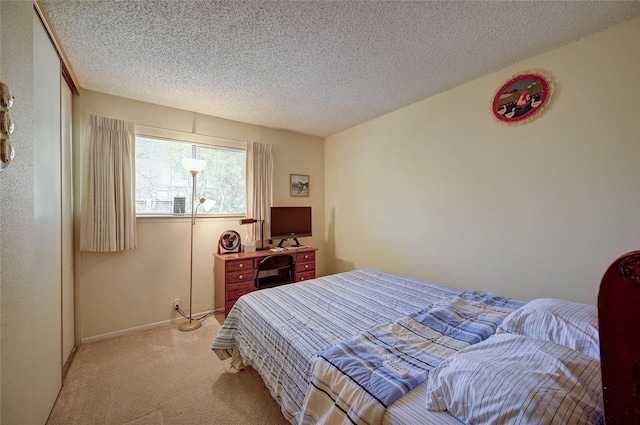 4405 Tophill Ln, Irving, TX 75038 - bedroom featuring baseboards, light carpet, and a textured ceiling