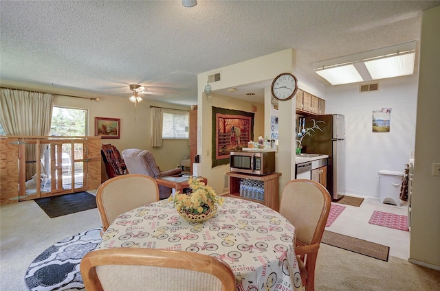 4405 Tophill Ln, Irving, TX 75038 - dining area featuring visible vents, a textured ceiling, plenty of natural light, and light colored carpet