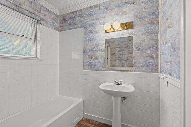 bathroom with crown molding, a wainscoted wall, wallpapered walls, tile walls, and wood finished floors